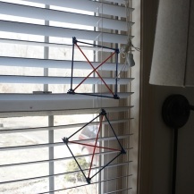 "kites" hanging in the window.